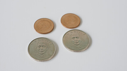 1 yuan and 10 yuan Taiwan coin close-up, isolated on a white background.