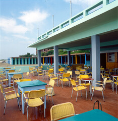 Lido di Venezia. Spiaggia dei Murazzi con sedie e tavoli di ristorante all' aperto