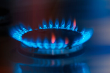 Gas burner on dark background. Natural gas flame. Blue flames from gas stove burner