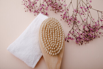Wooden body massage brush on a pink backgorund. Body care concept