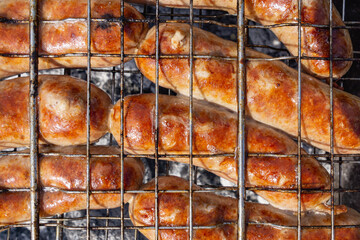 Grilled sausages on coals. Grill.