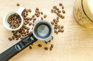 coffee grinder and beans on wooden background to make delicious coffee for your happy mood