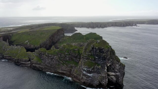 The cliffs and sea stacks An Tor Mor and the Wishing Stone at Port Challa on Tory Island, County Donegal, Ireland