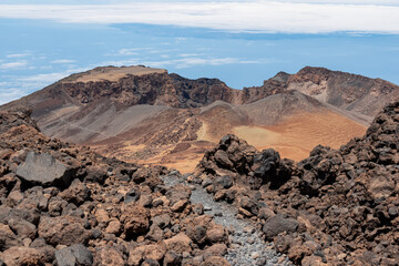 Hiking trail over volcanic desert terrain leading to summit of volcano Pico del Teide from Pico Viejo, Mount Teide National Park, Tenerife, Canary Islands, Spain, Europe. Solidified lava, ash, pumice