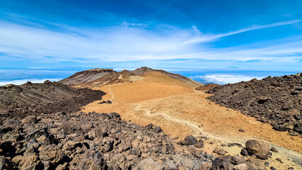 Panoramic view on crater of mountain Pico Viejo on hiking trail to volcano Pico del Teide, Mount Teide National Park, Tenerife, Canary Islands, Spain, Europe. Walking on barren volcanic desert terrain