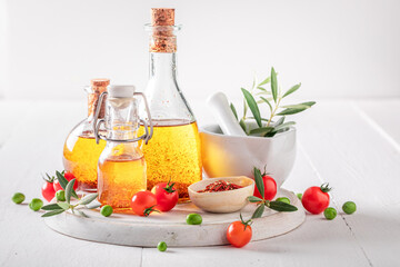 Delicious and healthy oil in bottle with dried tomatoes.