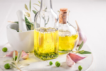Healthy and delicious oil in bottle with garlic.