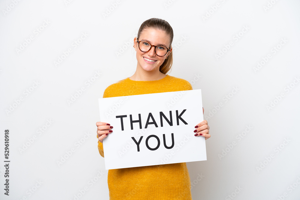 Wall mural young caucasian woman isolated on white background holding a placard with text thank you with happy  - Wall murals