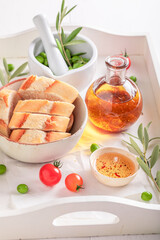 Homemade bread served with tomatoes oil with herbs.