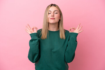 Young caucasian woman isolated on pink background in zen pose - obrazy, fototapety, plakaty