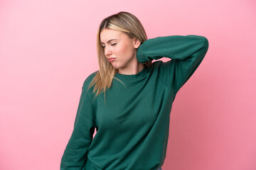 Young caucasian woman isolated on pink background with neckache