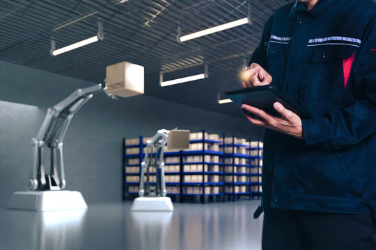 Asian Man Engineer hold smartphone touch touching UI screen interface for manufacturing industry technology Product export and import future Robot cyber warehouse arm robot future technology