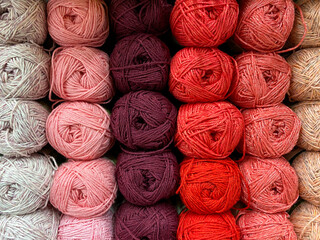 multi-colored threads. A selection of wool yarns on display. Yarn for knitting winter clothes