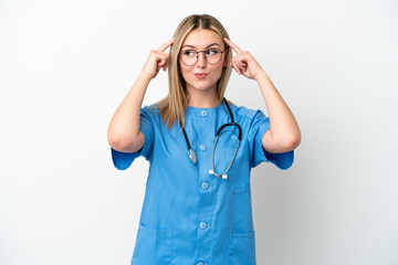 Young surgeon doctor woman isolated on white background having doubts and thinking