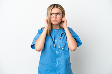 Young surgeon doctor woman isolated on white background frustrated and covering ears