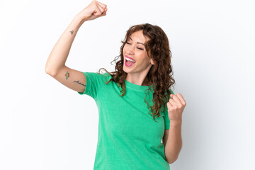 Young woman with curly hair isolated on white background celebrating a victory