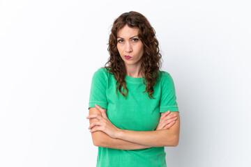 Young woman with curly hair isolated on white background with unhappy expression