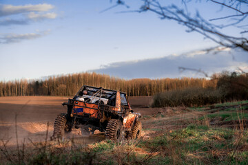 Off-road car on the race by the forest © Tomasz