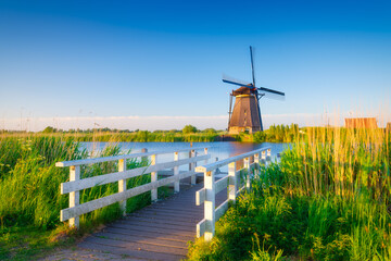 Kinderdijk National Park in the Netherlands. Windmills at the day time. A natural landscape in a historic location. Reflections on the water surface. Dutch canals. UNESCO World Heritage Site. © biletskiyevgeniy