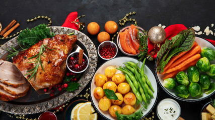Traditional Christmas dinner on dark background.