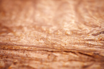 Extreme closeup of crumpled brass foil texture