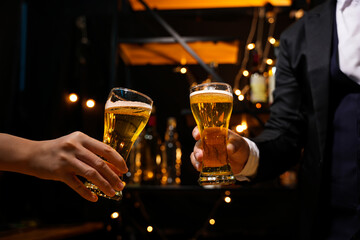 food and drink male friends are happy drinking beer and clinking glasses at a bar or pub.