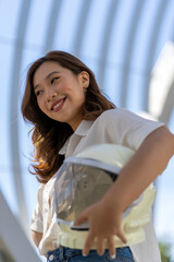 asian woman smiling with her astronaut helmet
