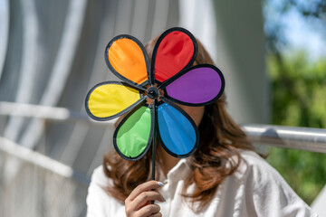 asian woman hiding behind her windmill