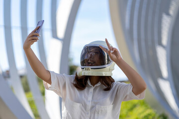 Asian woman dressed as an astronaut taking a photo