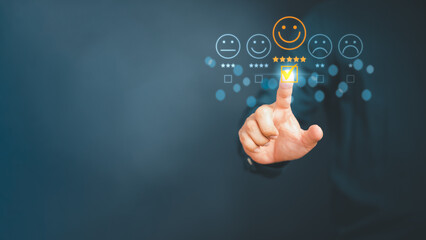 Man touching the virtual screen on the happy smiley face icon to give satisfaction in service. Rating very impressed. Customer service,  testimonial satisfaction concept. - 529617967