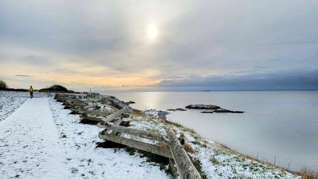 Beautiful view of a lakeshore in winter during the sunset