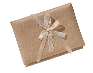 A gift box made of beige textured fabric with a lace bow, isolated on a transparent background, top view. Beautiful gift box covered with cream fabric, high definition, large depth of field