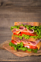 Club sandwich with ham, cheese, tomato and lettuce. 
