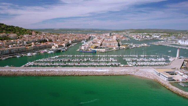The drone aerial footage of the old town center of Sete in the South of France. Two urbanised islands surrounded with ancient canals between the Mediterranean Sea and the Pond of Thau.