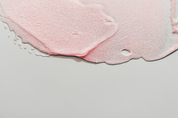 Beauty gel texture with pink and golden particles. Shining highlighter background with brush strokes