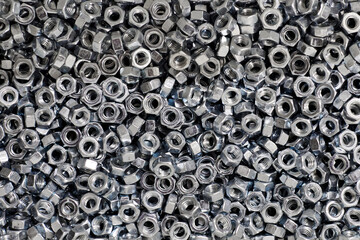 Bunch of galvanized hexagon nuts for bolts for fasten multiple parts together, hardware fasteners