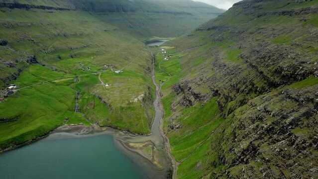 Aerial view of a lagoon in Saksun village, Faroe Islands. Lagoon in beautiful green nature in Saksun. Mist faroese nature. High quality 4k footage.