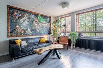 Interior with slatted window and a lot of plants and yellow design
