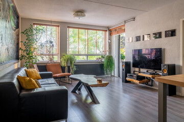 Interior with slatted window and a lot of plants and yellow design