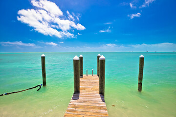 Idyllic turquoise bay and wooden dock in Islamorada on Florida Keys
