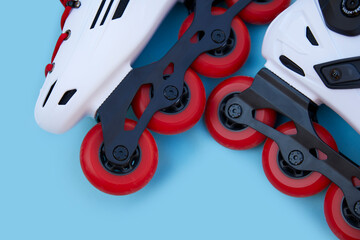 Red inline skate wheels on blue background with copyspace