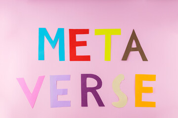 Metaverse word made from multicolored paper letters. Metaverse lettering on a pink background. Virtual reality technologies concept