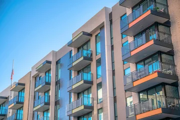 Poster Condominiums with balconies against blue sky in Tucson Arizona neighborhood © Jason
