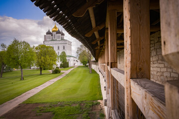 Pskov Kremlin on the Velikaya River, a stone fortress wall with a watchtower. The city of Pskov