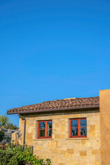 Home exterior with stone wall against blue sky at Del Mar Southern California
