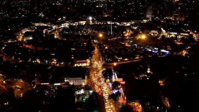 An aerial night hyperlapse shot of Connaught Place with cars moving around at New Delhi, India