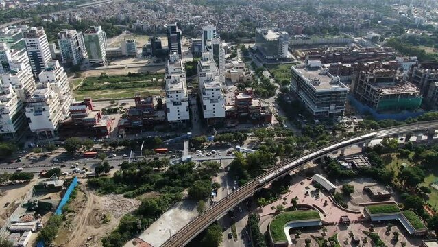 An aerial Drone shot of Delhi metro entering metro station in New Delhi,India
