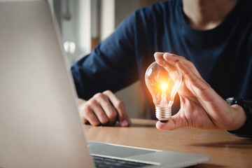 Close up hand choose light bulb or lamp with bright for human resources or leadership and creativity thinking idea motivation or vision and knowledge learning.