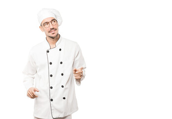 Friendly young chef doing a gesture of admiration