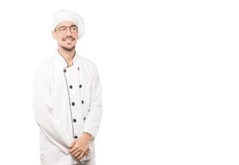 Happy young chef posing against background